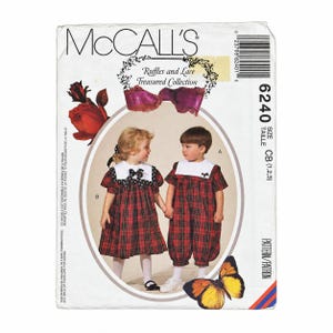 May include: McCall's sewing pattern 6240 for children's clothing, featuring a red and black plaid dress with a white collar and a matching plaid romper with a white collar. The envelope displays the text Ruffles and Lace Treasured Collection.
