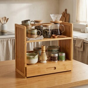 Bamboo countertop organizer with two shelves and pull-out drawer styled as a coffee and tea station.