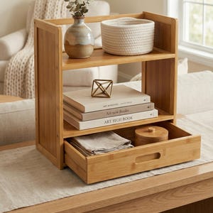 Bamboo organizer with pull-out drawer used as a tabletop bookshelf and decor organizer in a living space.