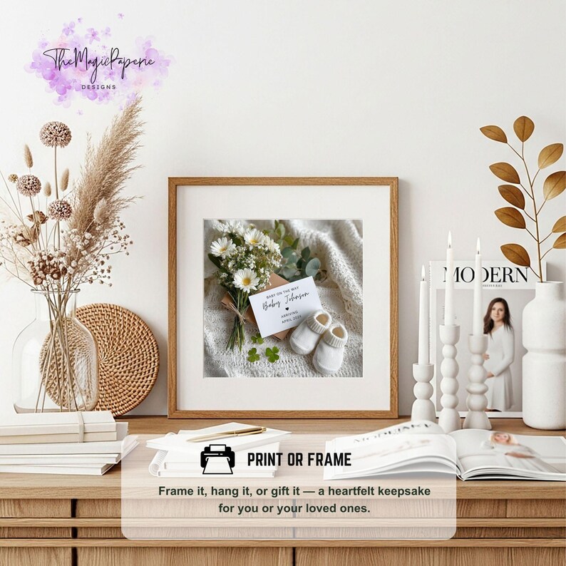 May include: A framed print featuring a baby announcement with a bouquet of flowers and baby booties. The announcement card reads "Baby Johnson" with the expected arrival date. The frame is brown and the print is displayed on a wooden table.