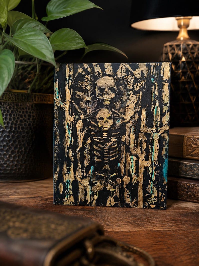 May include: A rectangular canvas painting featuring a central skeletal figure with a skull head, rendered in thick, textured gold paint against a deep black background. Hints of teal blue are visible within the abstract, vertical brushstrokes.