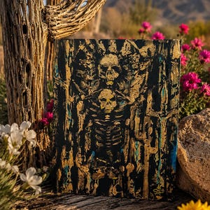 May include: A rectangular canvas painting featuring a textured black background with gold and blue paint accents. The artwork depicts a central skeletal figure with a skull and ribcage, surrounded by abstract vertical lines and organic shapes.