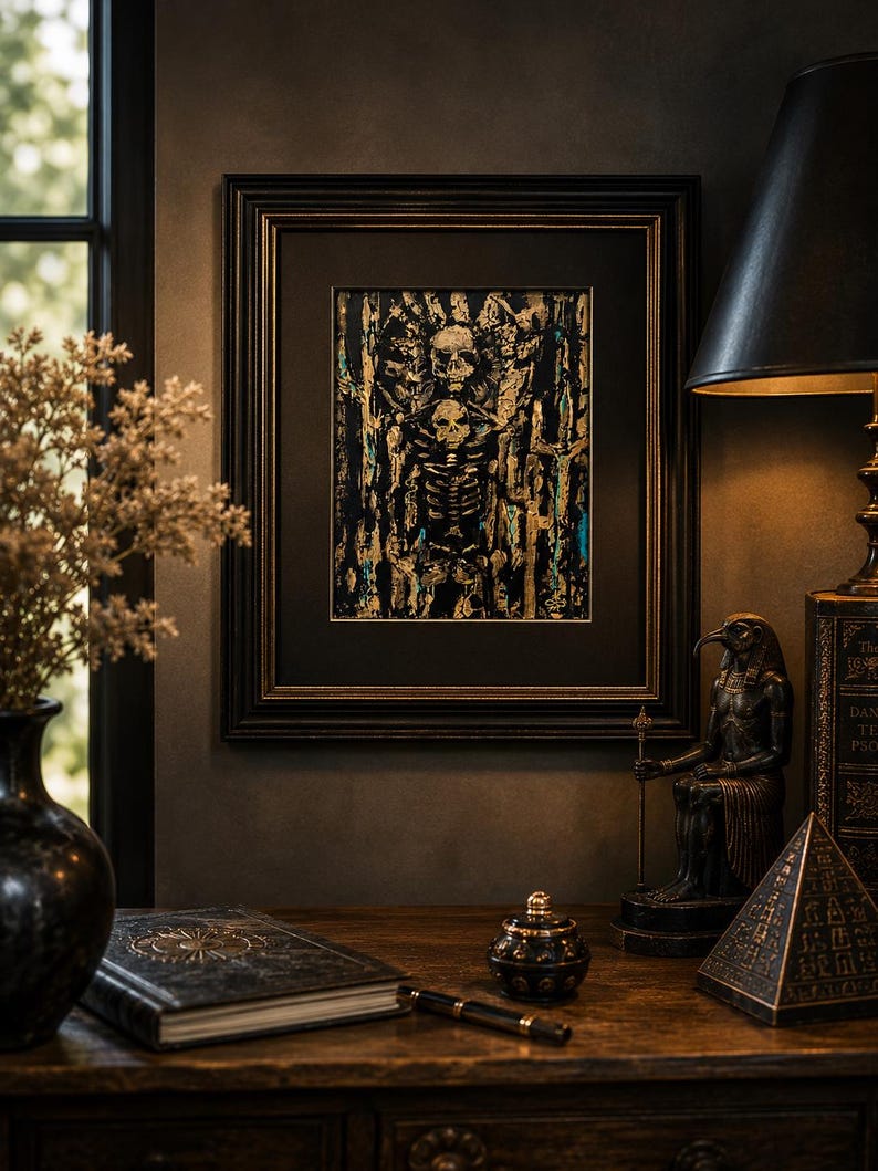 May include: A framed rectangular artwork featuring a central skeletal figure in black, gold, and teal paint. The piece is enclosed in a dark, ornate wooden frame with a black mat, showcasing textured brushstrokes and a detailed skull and ribcage motif.