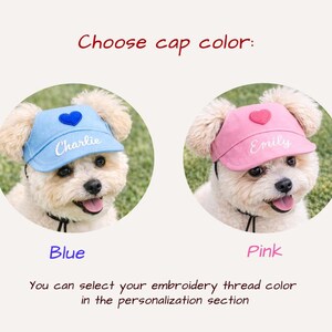May include: Two pet visor caps, one light blue and one pink, each featuring a heart patch on the front and custom embroidery. The blue cap displays the name Charlie, and the pink cap displays the name Emily. Text reads: Choose cap color.