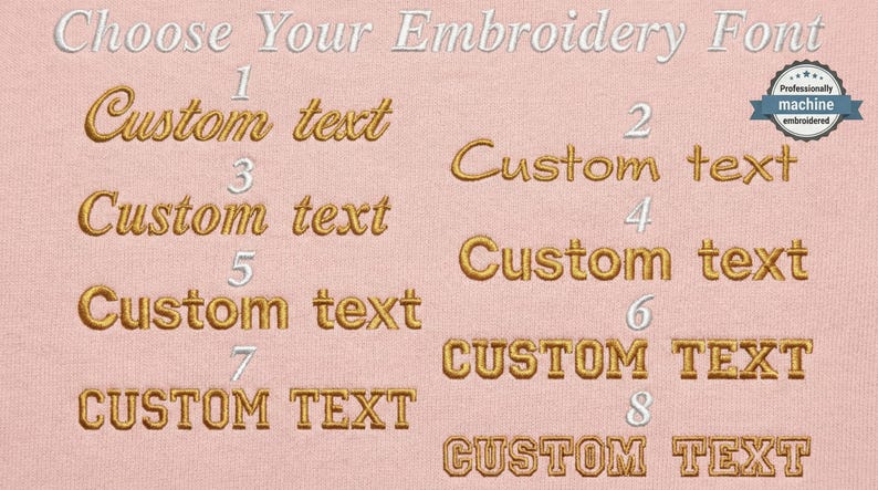 May include: A light pink fabric background displays eight numbered embroidery font options in gold thread. The text reads Choose Your Embroidery Font at the top, with a circular badge stating Professionally machine embroidered in the top right corner.