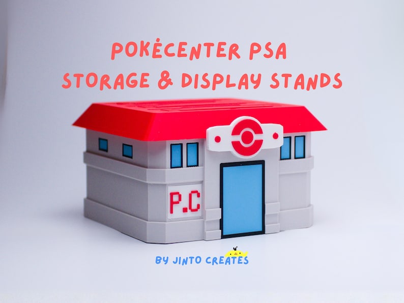 May include: A grey and white Pokecenter PSA storage and display stand with a red roof and blue door. The stand has the letters "P.C." on the side and the text "BY JINTO CREATES" at the bottom.