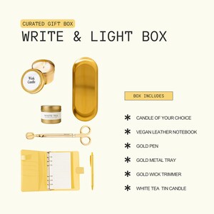 The image is a curated gift box containing various items such as a candle, a notebook, a pen, a wick candle, a pair of scissors, and a metal tray.