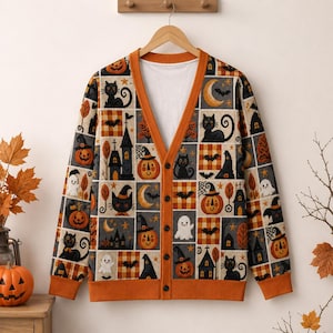 May include: A long-sleeve V-neck cardigan featuring a grid pattern of Halloween-themed illustrations including black cats, orange pumpkins, ghosts, bats, crescent moons, and haunted houses, finished with solid orange ribbed cuffs and a button front.
