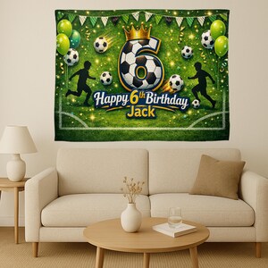 May include: A green and white soccer-themed birthday banner with the number 6, a soccer ball, and the text "Happy 6th Birthday Jack." The banner also features soccer players, soccer balls, balloons, and a gold crown.
