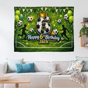 May include: A green and white soccer-themed birthday banner with the text "Happy 6th Birthday Jack." The banner features a large number six with a soccer ball design, soccer balls, balloons, and silhouettes of soccer players.
