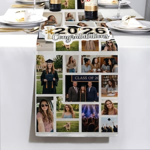 May include: A white table runner featuring a collage of photos, with the text "2026 Congratulations" at the top. The collage includes images of people, a graduation ceremony, and a dog. The runner is on a white table.