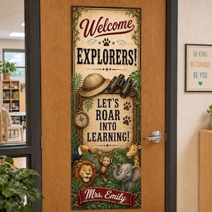 May include: A vertical rectangular door banner featuring the text Welcome EXPLORERS! LET'S ROAR INTO LEARNING! and Mrs. Emily. The design includes a pith helmet, binoculars, a compass, and illustrations of a toucan, lion, monkey, giraffe, and elephant.