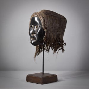 Dan Deangle Mask With Braided Hair On Stand Liberia