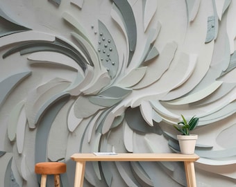 May include: A large, abstract wall art piece with a floral design in shades of white, gray, and green. A small wooden table with a plant in a white pot and a small orange stool are in front of the wall art.