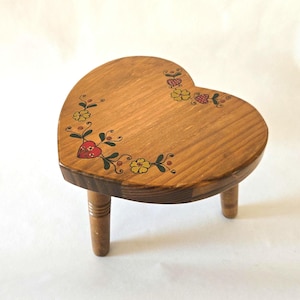 May include: A handmade wooden sign with the text "Welcome" in a playful font. The sign features a distressed finish and a simple, rustic design, perfect for a front door or entryway. The sign is rectangular and appears to be made of reclaimed wood.