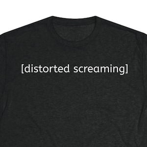 May include: Dark grey t-shirt featuring the white text "[distorted screaming]". The top has a crew neck and short sleeves. The material looks soft and heathered.