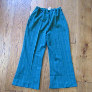 May include: A white ceramic mug with a black handle and the text "But First, Coffee" in a black, bold font. The mug is on a white surface. The mug is 4 inches tall.