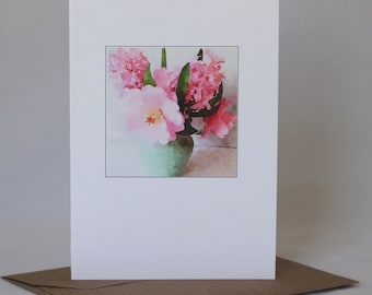 May include: A watercolor painting of pink flowers in a green vase. The flowers are arranged in a bouquet and the vase is sitting on a table.