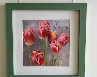 May include: A framed print featuring a bouquet of red and yellow tulips. The artwork is set within a white mat and a green frame. The text "Say it with flowers" is visible on the print.