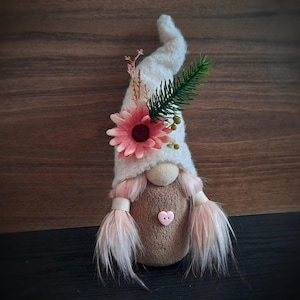 Plush soft cozy cute handmade girl gnome with pink hair, beige hat and forest flowers.