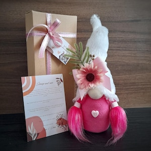 Plush soft cozy cute handmade girl gnome with pink hair, white hat and forest flowers.