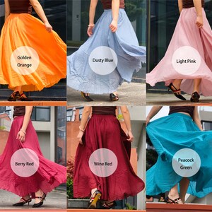 May include: A collection of six long, flowing skirts in various solid colours including golden orange, dusty blue, light pink, berry red, wine red, and peacock green. Each skirt features a gathered elastic waistband and a full, flared silhouette.