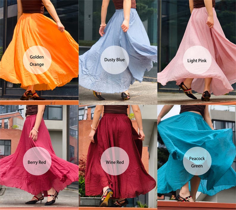 May include: A collection of six long, flowing skirts in various solid colours including golden orange, dusty blue, light pink, berry red, wine red, and peacock green. Each skirt features a gathered elastic waistband and a full, flared silhouette.