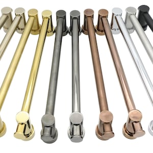 May include: A collection of cabinet pulls in various metallic finishes, including gold, silver, bronze, and black. Each pull features a cylindrical bar with decorative end pieces, arranged against a white background. These pulls are designed for furniture and cabinetry.
