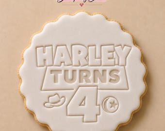 May include: A round scalloped cookie with white icing featuring the embossed text HARLEY TURNS 4, accompanied by a small cowboy hat icon and a sheriff badge icon. The Stamp My Bake logo is visible at the top of the image.