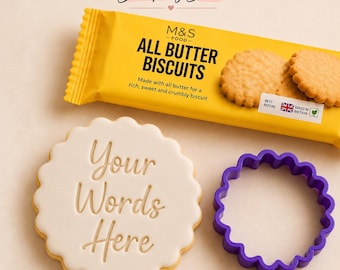 May include: A yellow package of M&S Food All Butter Biscuits, a round white cookie embossed with the text Your Words Here, and a purple scalloped circular cookie cutter. The package features the Stamp My Bake logo at the top.