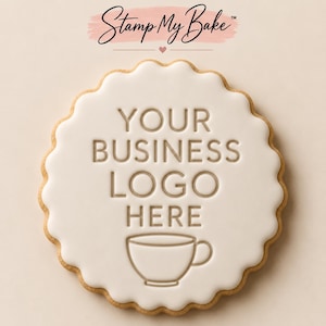 May include: A round, scalloped-edge biscuit topped with smooth white icing. The icing is embossed with the text "YOUR BUSINESS LOGO HERE" in a clean, sans-serif font, positioned above a simple line-art illustration of a coffee cup.