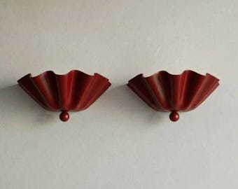 May include: Two wall sconces with a ruffled, fan-like design in a deep red finish labeled as USC CARDINAL. Each fixture features a central spherical accent at the base, creating a symmetrical appearance with a wide, pleated opening.