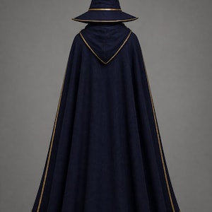 May include: A navy blue witch costume, featuring a pointed hat and a long cape. The hat and cape are trimmed with gold-colored accents. The costume is made of a dark fabric, and the overall design is simple and elegant.