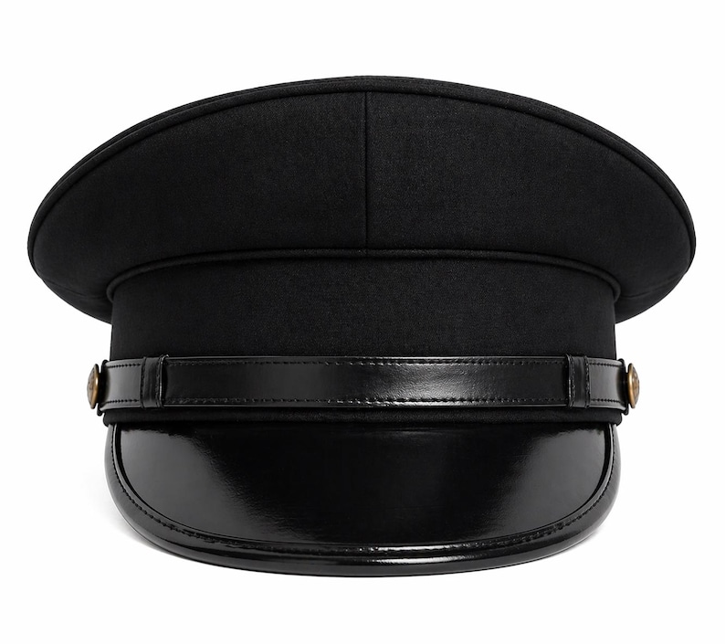 May include: A black hat with a rounded top and a shiny, curved brim. A black leather band with gold-colored buttons encircles the hat. The hat is a classic style, suitable for various occasions.