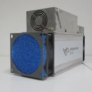 Könnte beinhalten: Ein silbernes und graues Whatsminer M21S Kryptowährungs-Mining-Gerät. Das Gerät hat einen blauen Filter und einen Lüfter. Der Text "whatsminer M21S" ist auf der Seite aufgedruckt. Die Maschine steht auf einer weißen Oberfläche.