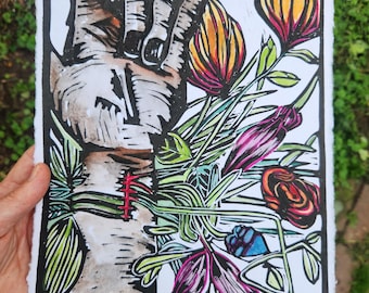 May include: A block print on textured paper featuring a stylised tree trunk with a red stitched wound, surrounded by vibrant flowers in shades of orange, pink, and green. The artwork includes the handwritten text 8/12 HIS WOUNDS 2024.