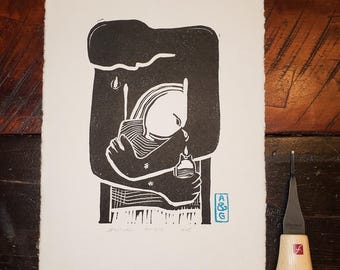 May include: Black and white woodcut print of a person holding another person. The print is signed "Hank Willis" and has a small blue stamp that says "A&G".