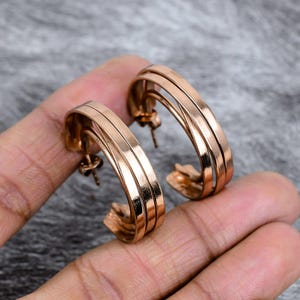 Puede incluir: Pendientes de aro de oro rosa con un diseño de triple banda. Los pendientes tienen un acabado pulido y cierre de poste. Los aros tienen aproximadamente 3,8 cm de diámetro.
