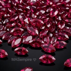 May include: A large collection of deep red, marquise-cut gemstones arranged in a pile. Each stone features multiple facets that reflect light, creating a brilliant appearance. The text MAsempire with a small diamond icon is visible in the lower area.