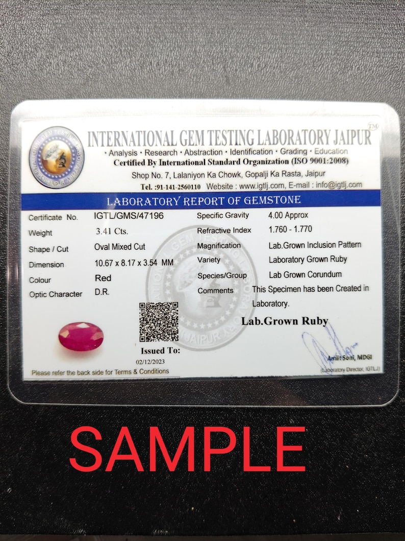 May include: A laboratory report of a red, oval-cut ruby, weighing 3.41 carats, with dimensions of 0.42 x 0.32 x 0.14 inches. The report is from the International Gem Testing Laboratory Jaipur, with the word "SAMPLE" in red.