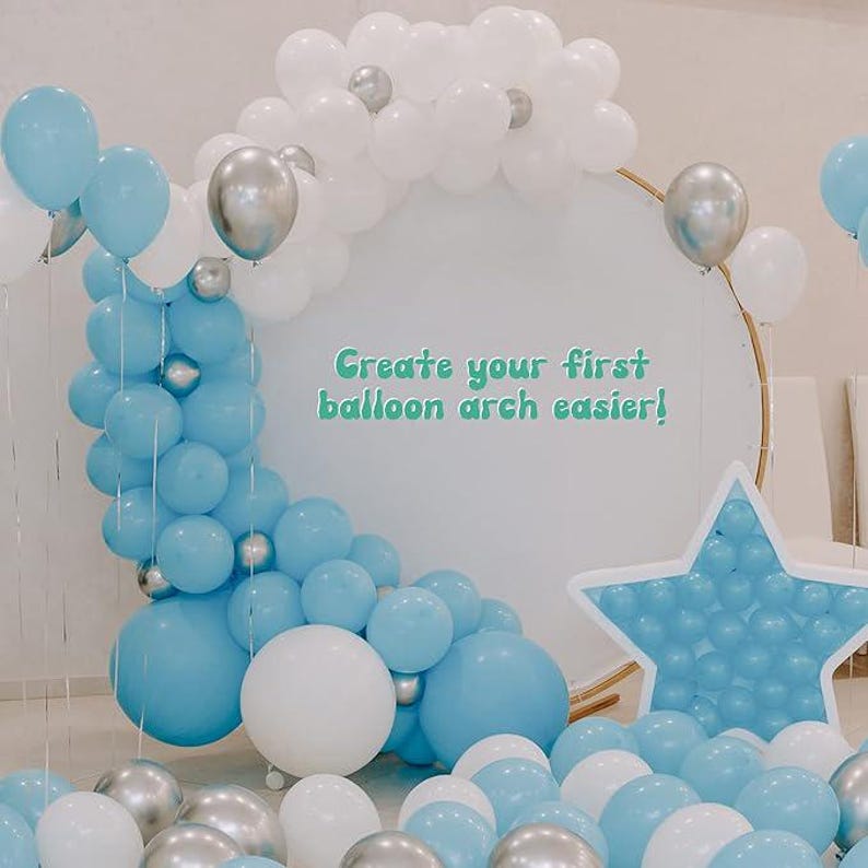 May include: A display of blue, white, and silver balloons arranged to form an arch and star shape. The text "Create your first balloon arch easier!" is visible. The balloons are for a party or event.