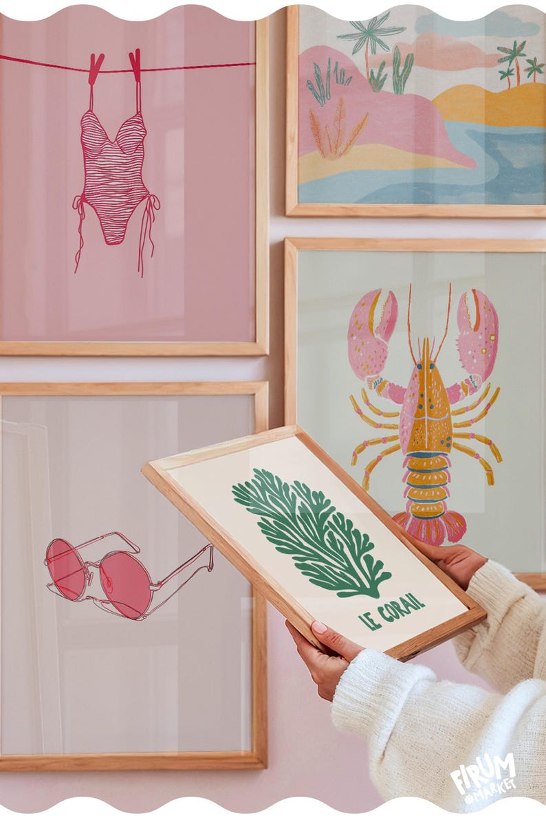 May include: A collection of framed art prints with a beach theme. Prints include a pink swimsuit, a lobster, sunglasses, and a green coral design with the text "LE CORAIL". The frames are light wood.