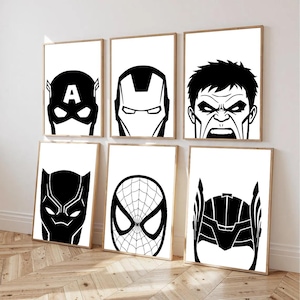 May include: Six framed art prints with black and white superhero portraits. The prints depict Captain America, Iron Man, Hulk, Black Panther, Spider-Man, and Thor. The artwork is displayed on a light wood floor.