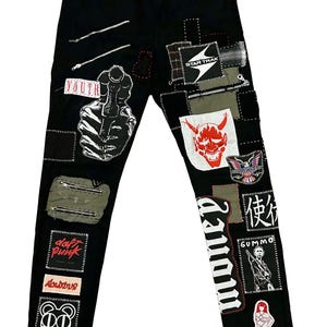 May include: Black denim jeans with various patches and embroidered details. Patches include text like "YOUTH", "DAFT PUNK", and "GUMMO", along with graphic designs and zippers. The jeans have a straight leg cut.