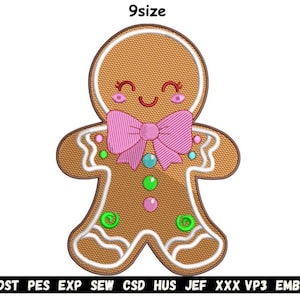 May include: A gingerbread man design with a pink bow tie, green and blue accents, and a smiling face. The image has the text "9size" at the top. The bottom of the image has the text "DST PES EXP SEW CSD HUS JEF XXX VP3 EMB".