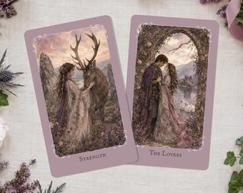 May include: Two tarot cards with fantasy art. One card is labeled "Strength" and depicts a woman with a deer. The other card is labeled "The Lovers" and shows a couple embracing. The cards have a lavender background with ornate borders.