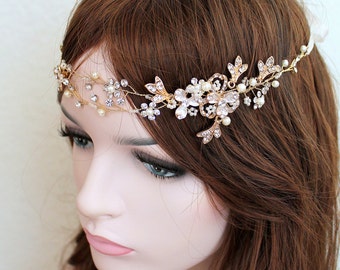 May include: A gold bridal headband with delicate floral and leaf designs, adorned with sparkling rhinestones and pearls.