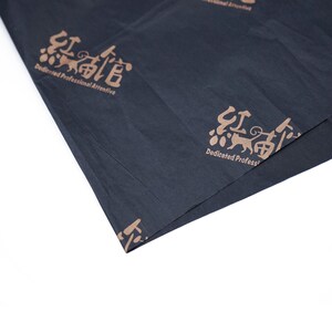 May include: Black tissue paper with a repeating pattern of a brown cat and Chinese characters. The text reads "Dedicated Professional Attentive".