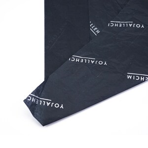 May include: Black tissue paper with the text "YOUALIEHCI" printed in white.