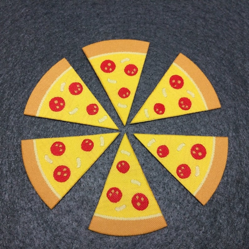 May include: Six yellow felt pizza slices with red pepperoni and white cheese. The slices are arranged in a circle on a gray background.
